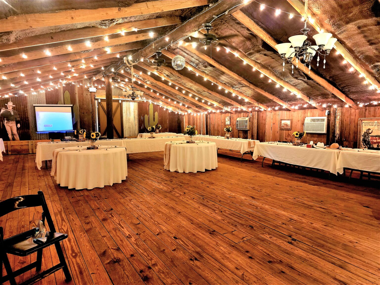 Wide reception setup inside the rustic event barn