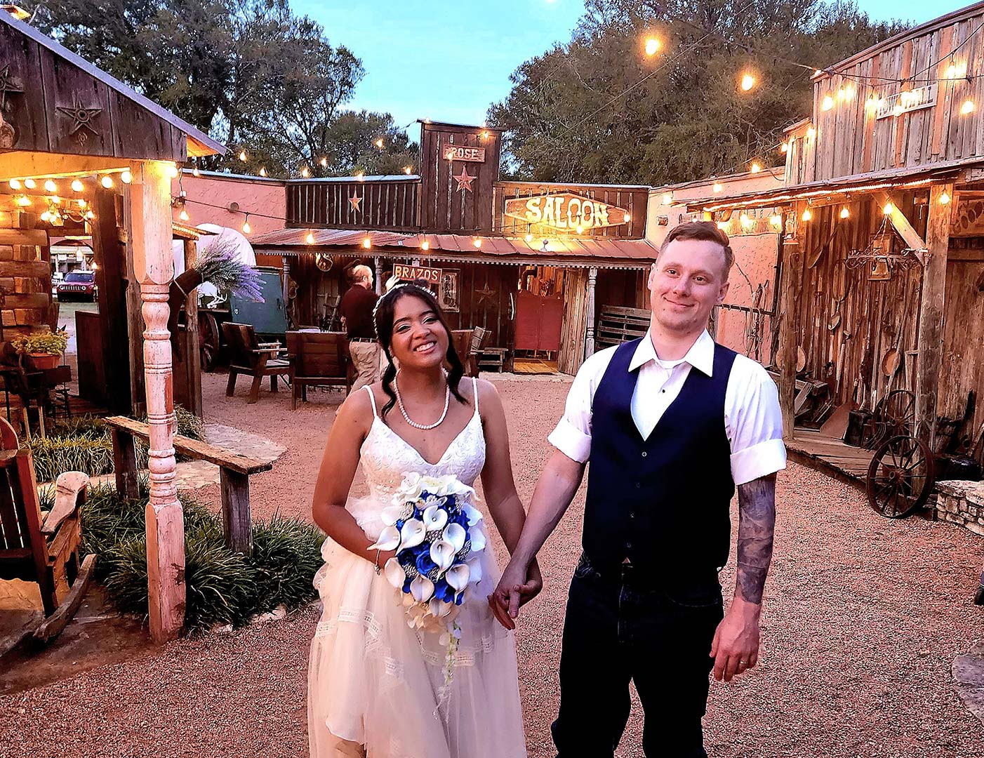 Wedding couple posing in front of the western town buildings