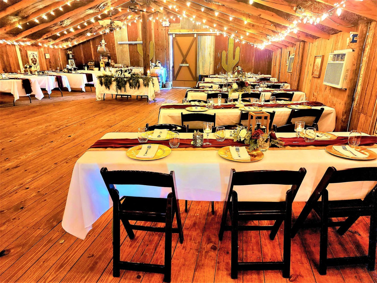 Decorated barn reception tables with rustic place settings