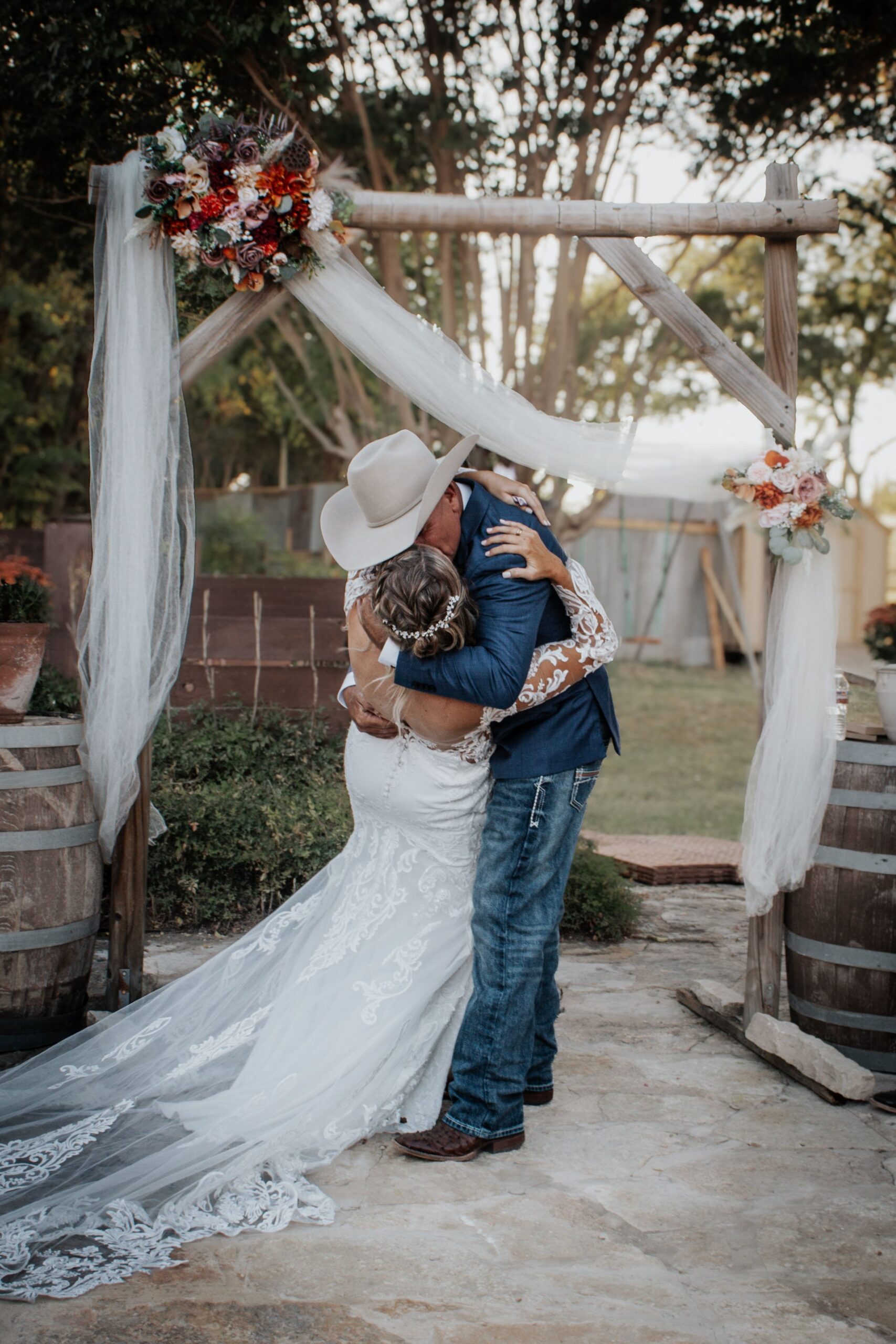 Couple sharing a dip kiss during wedding portraits