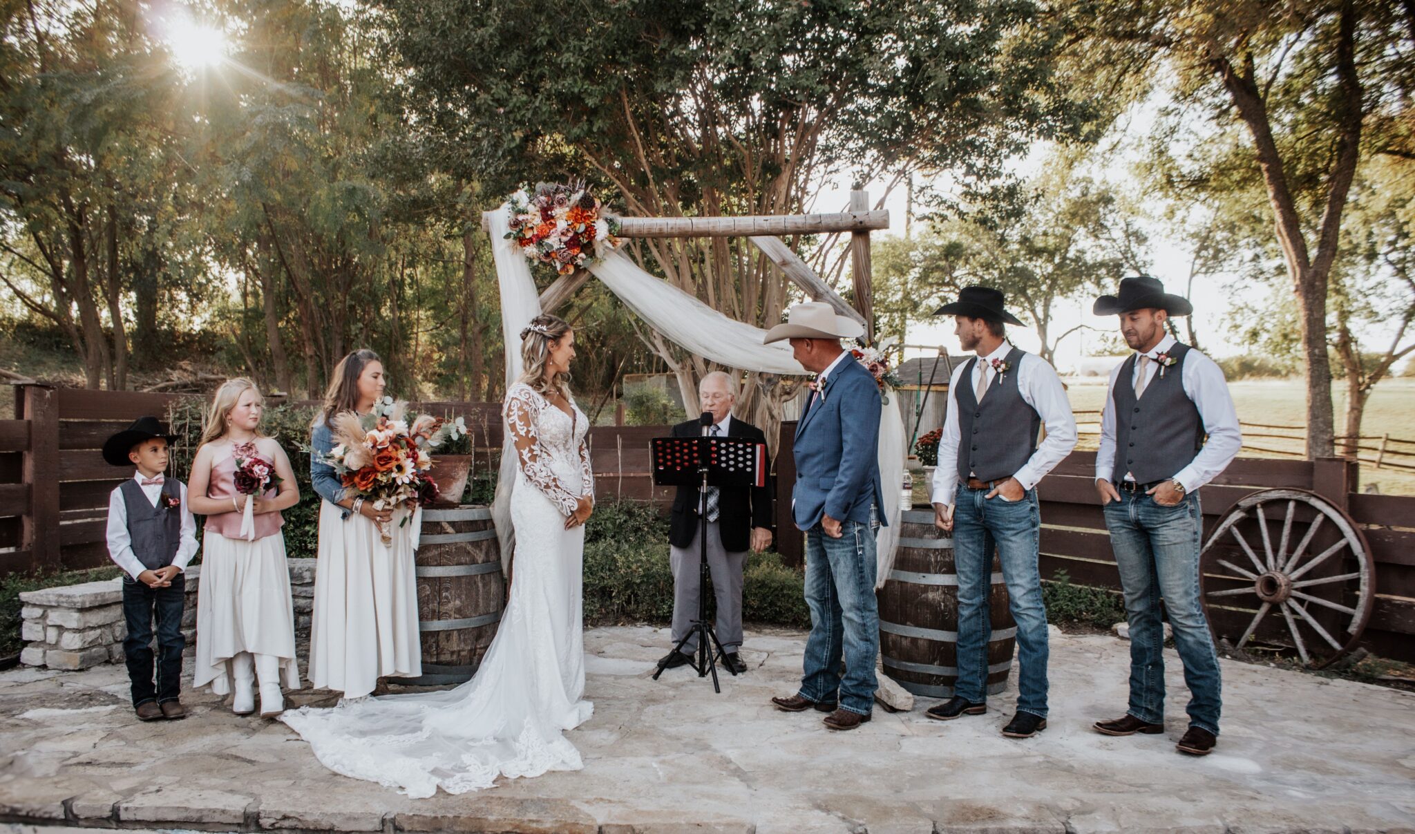 Wedding party gathered for photos at Chisholm Trail Rustic Venue