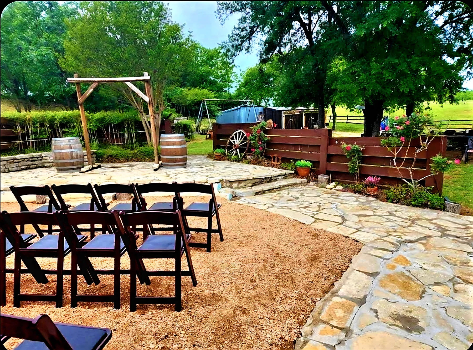 Ceremony aisle and arbor with western decor at Chisholm Trail Rustic Venue