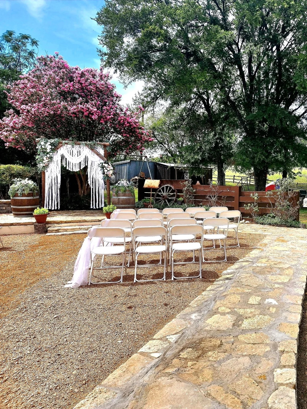 Outdoor ceremony arbor with floral details at Chisholm Trail Rustic Venue