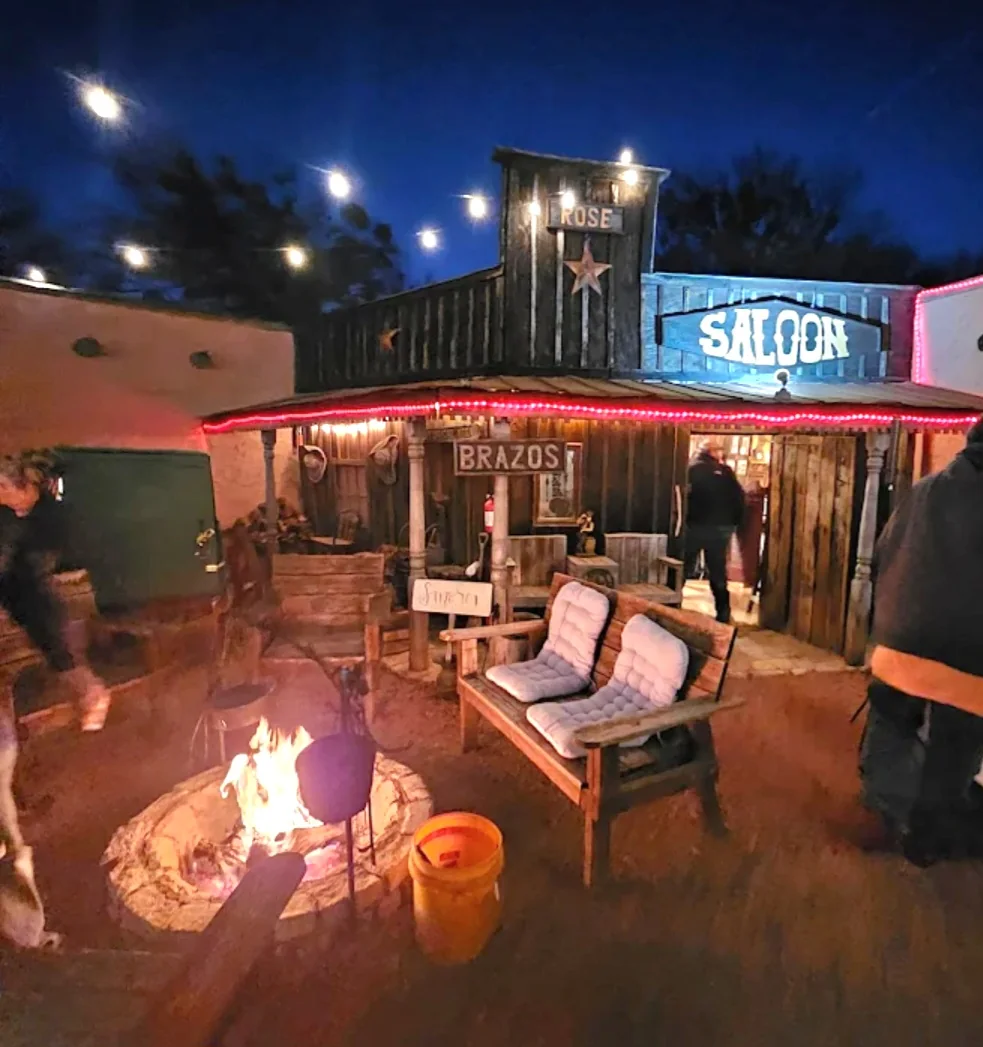 Saloon courtyard fire pit at night at Chisholm Trail Rustic Venue